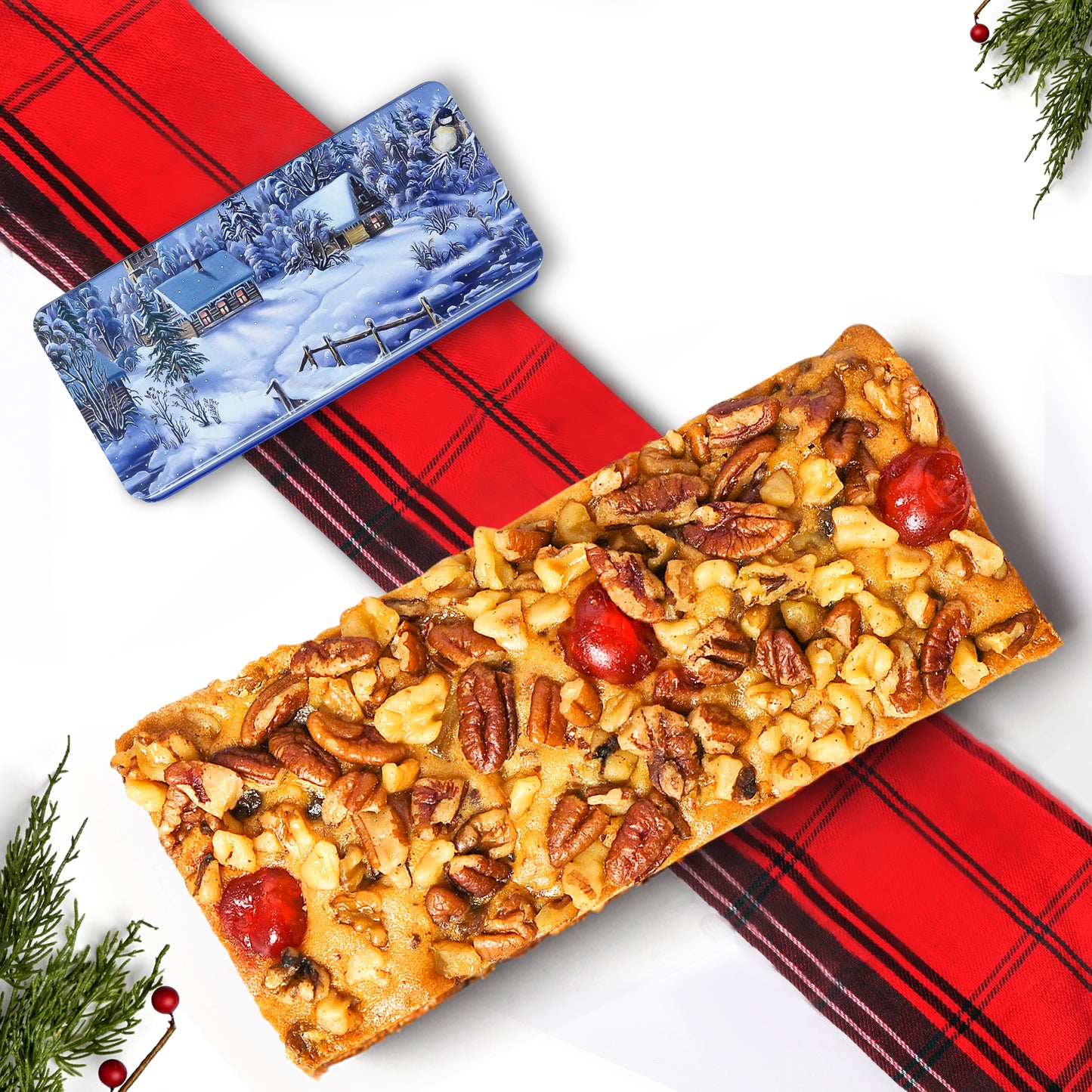 A slice of our 1lb Gourmet Christmas Fruit Cake, rich with cherries, pineapple, pecans, walnuts, and raisins, presented in a festive tin.